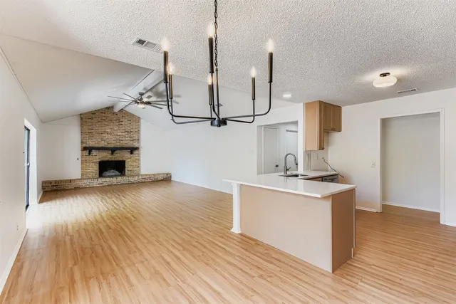a view of a kitchen with a sink and wooden floor