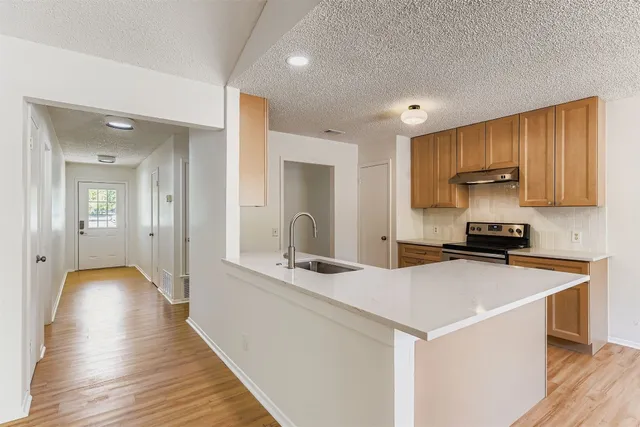 a kitchen with a sink and a refrigerator
