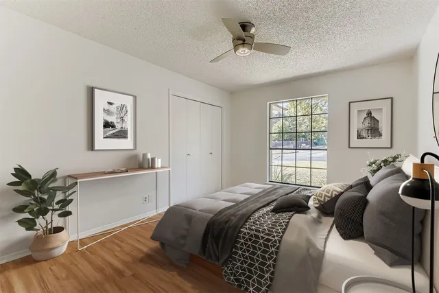 a bedroom with a large bed and a chandelier