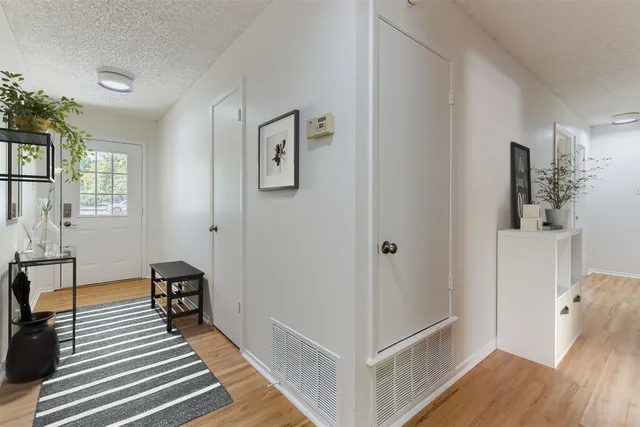 a view of a room with wooden floor and furniture