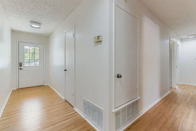 a view of hallway with wooden floor