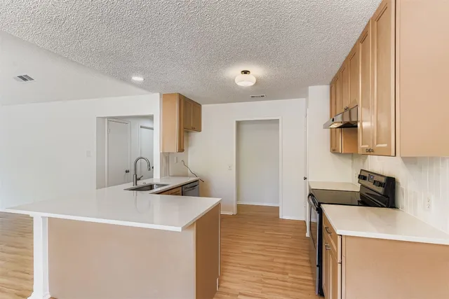 a kitchen that has a sink and a stove in it