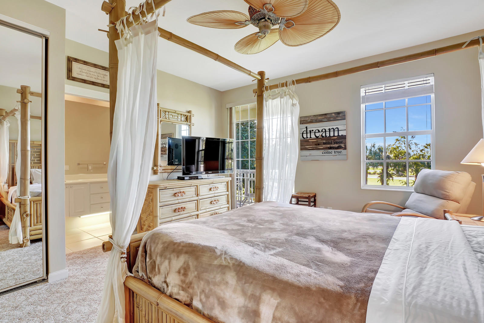 144 Radcliffe Court Jupiter, FL 33458 - Photo 11 of 28 a bedroom with a bed and a flat screen tv