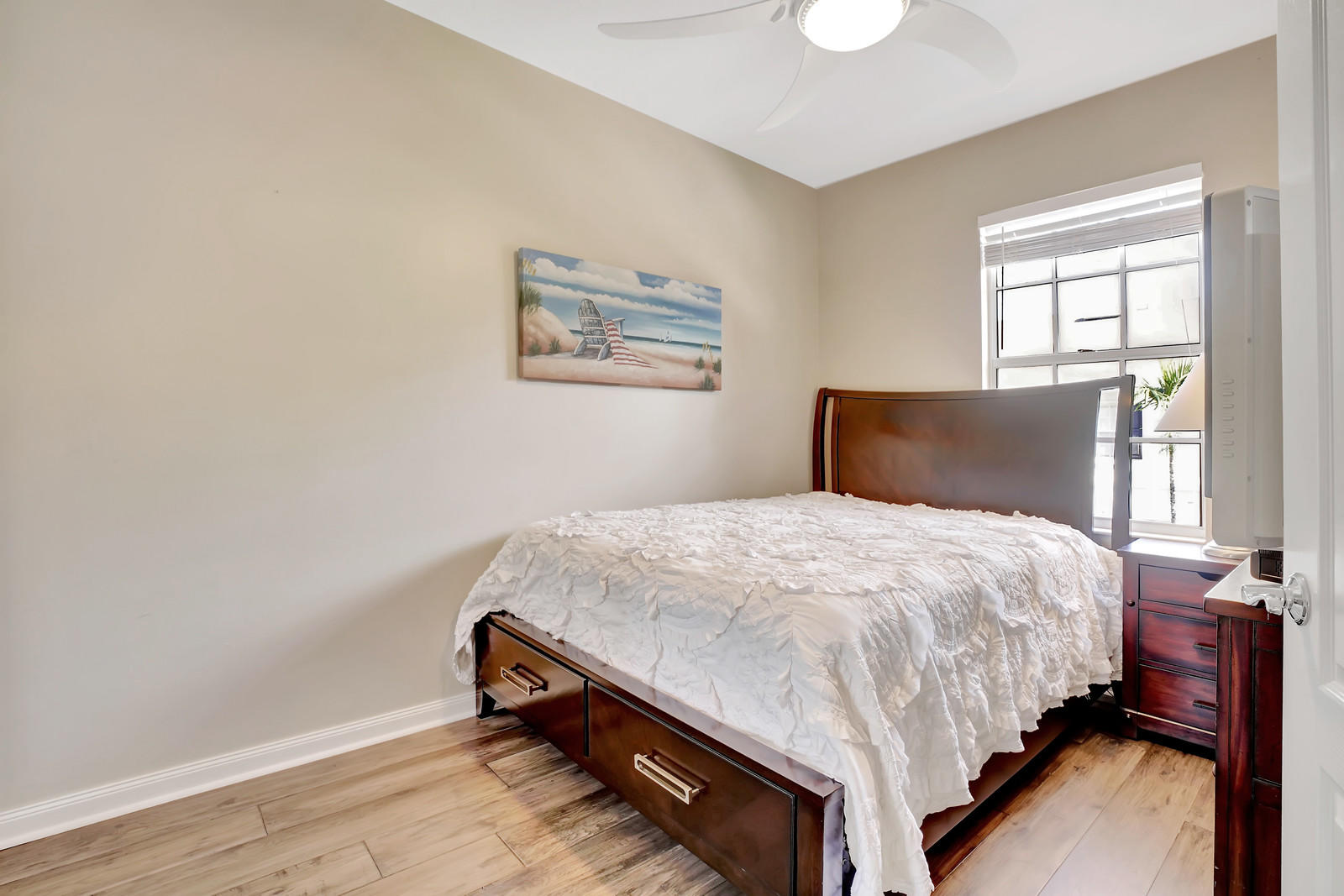 144 Radcliffe Court Jupiter, FL 33458 - Photo 13 of 28 a bedroom with a bed and a window