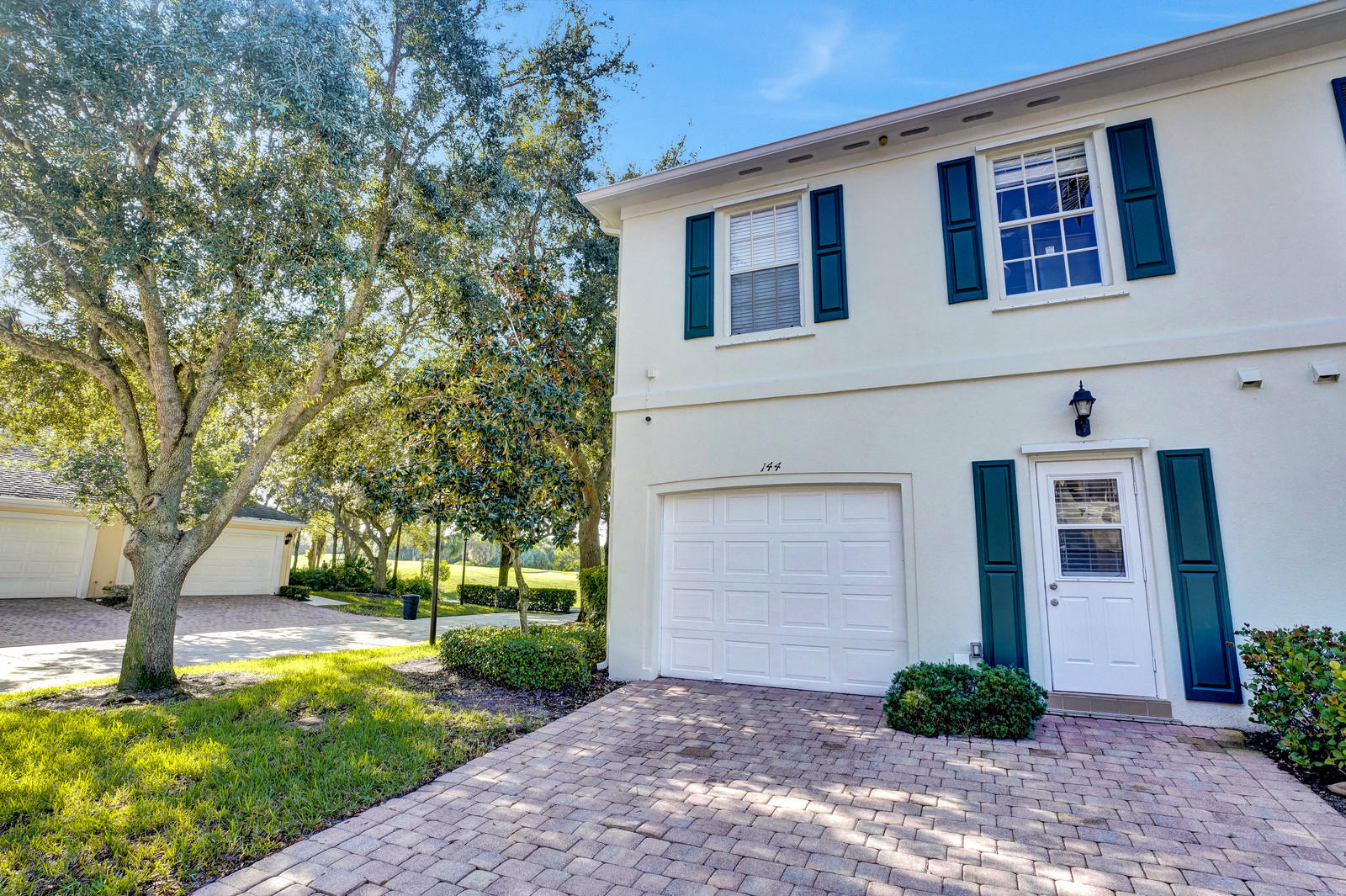 144 Radcliffe Court Jupiter, FL 33458 - Photo 20 of 28 a front view of a house with garden