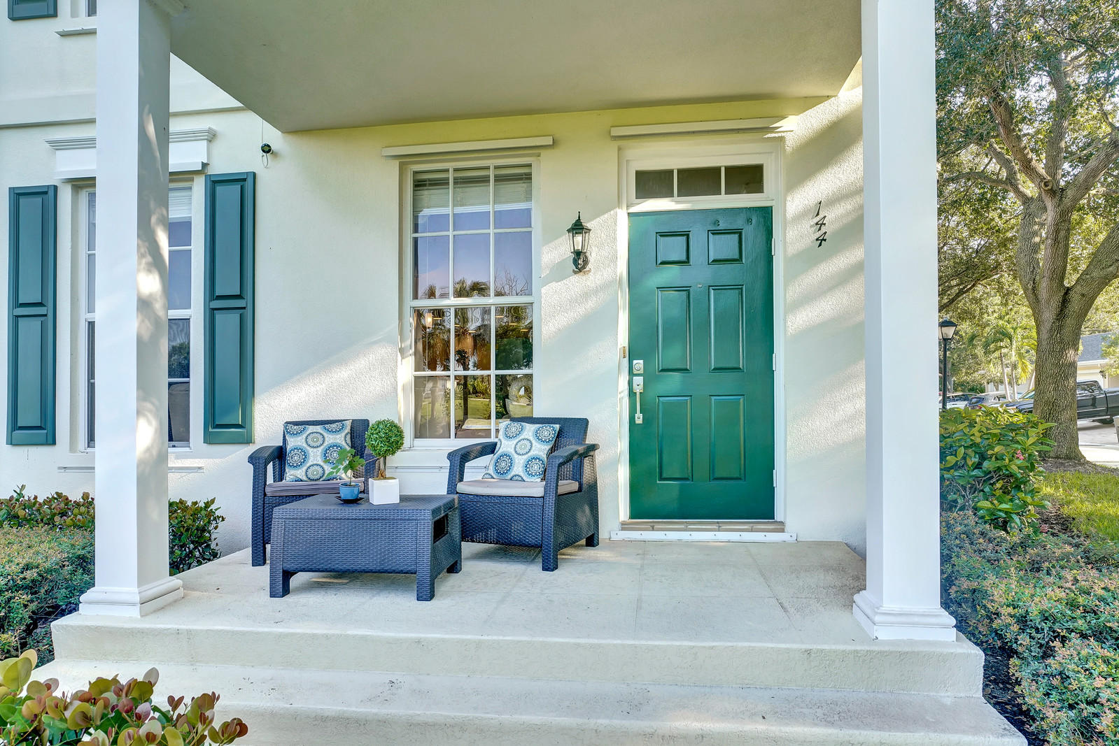 144 Radcliffe Court Jupiter, FL 33458 - Photo 4 of 28 a building outdoor space with patio furniture and potted plants