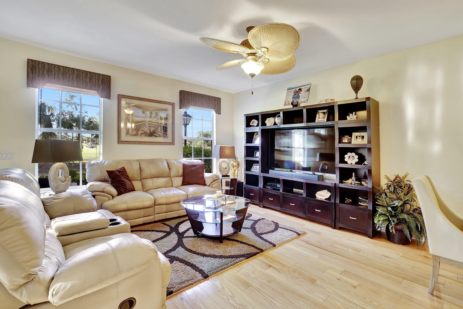 144 Radcliffe Court Jupiter, FL 33458 - Photo 5 of 28 a living room with furniture a dining table and a bookshelf