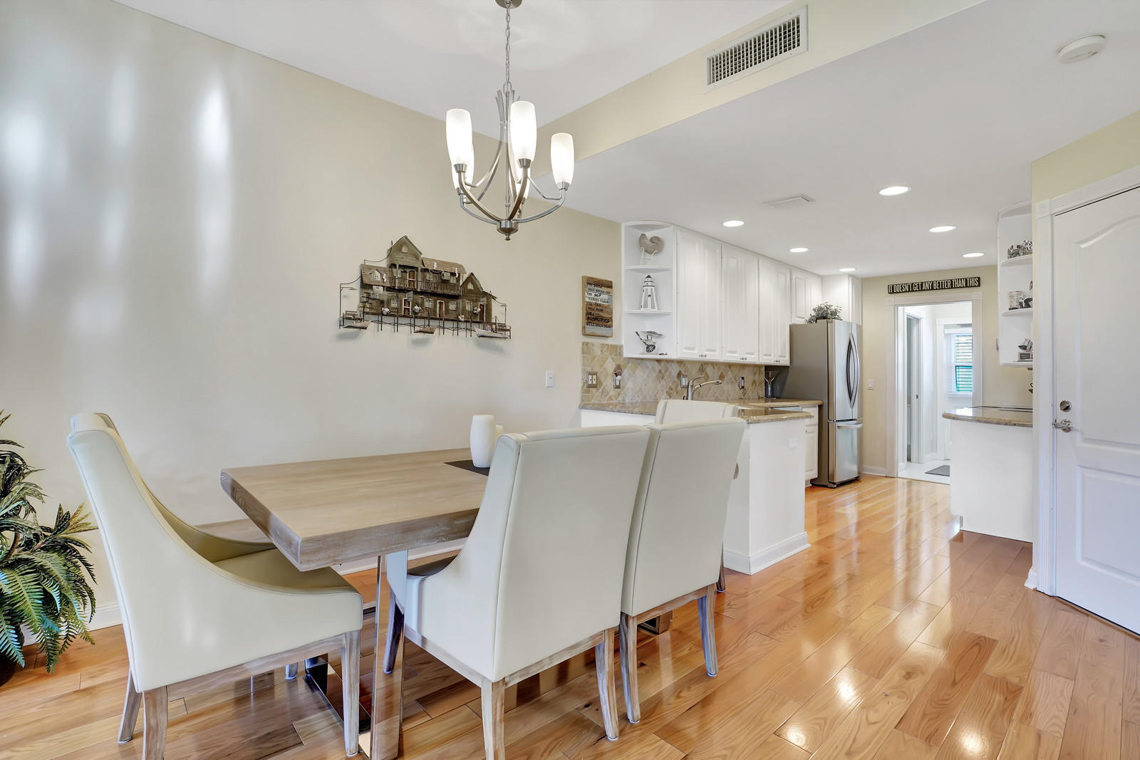 144 Radcliffe Court Jupiter, FL 33458 - Photo 7 of 28 a view of a dining room with furniture and wooden floor