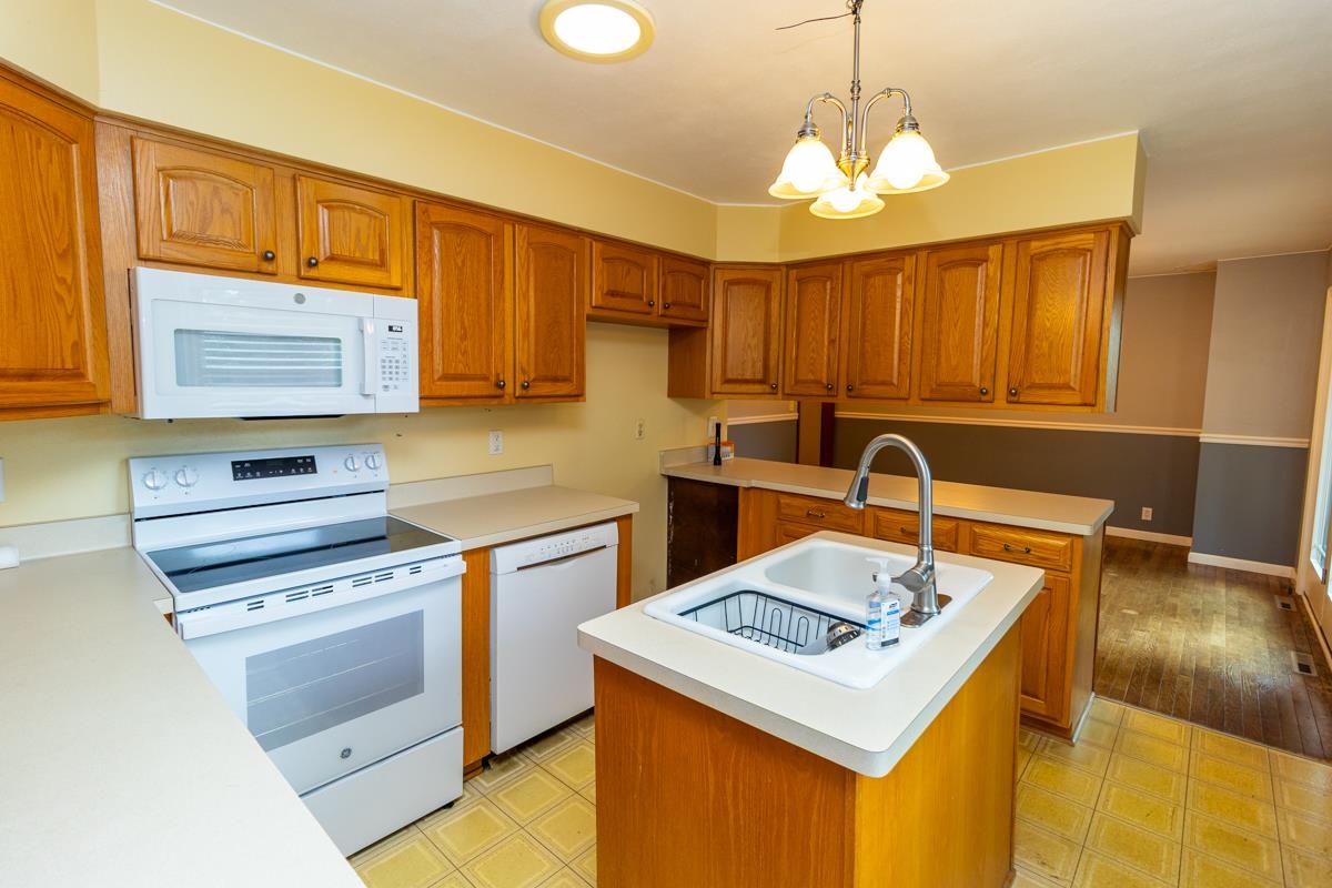 3096 East Water Road Byron, IL 61010 - Photo 8 of 29 a kitchen that has a sink a stove and a table in it