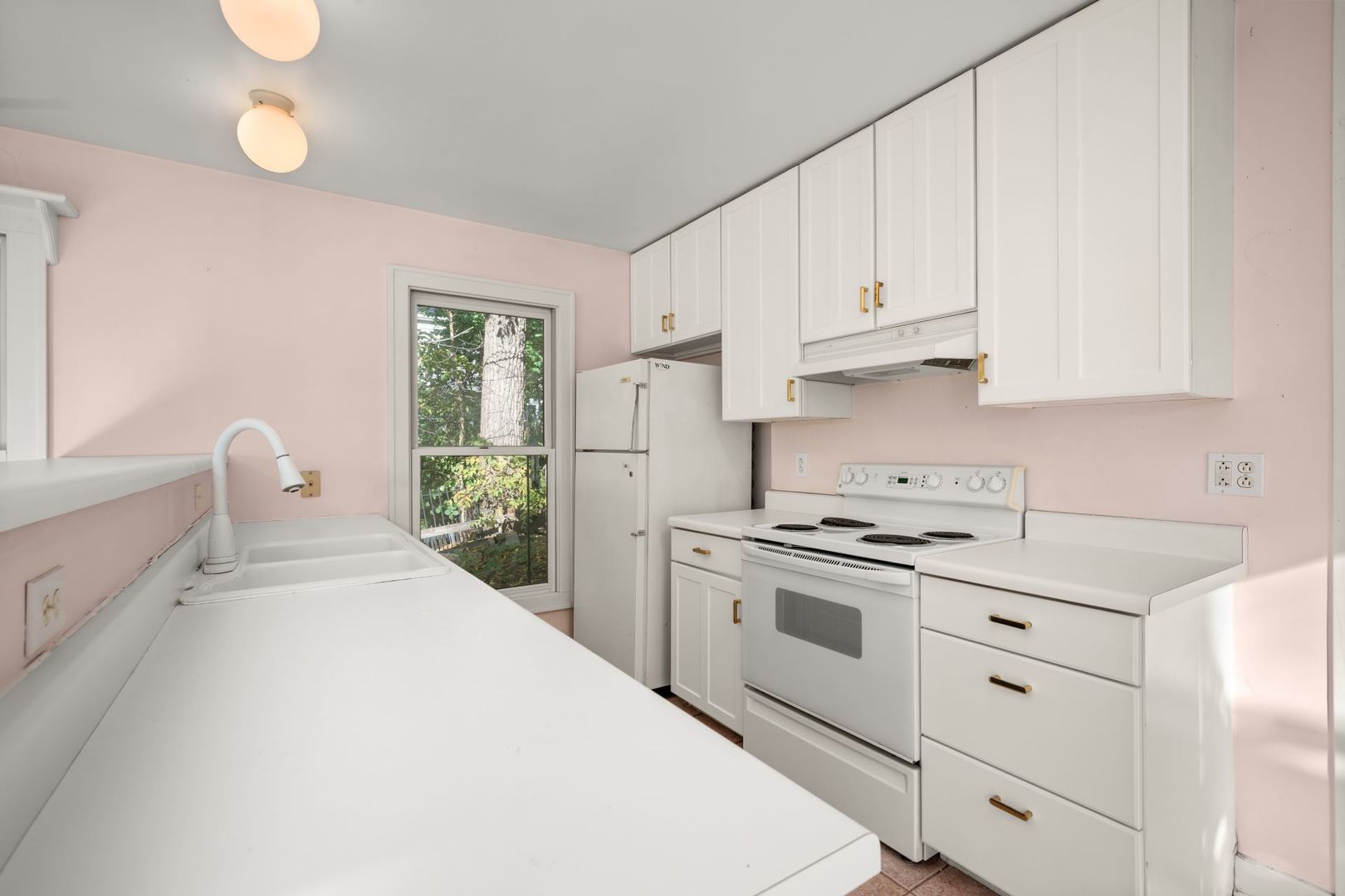 202 North Bennett Street Geneva, IL 60134 - Photo 11 of 40 a kitchen with white cabinets and white appliances