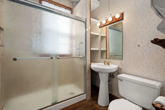 a bathroom with a sink toilet and shower