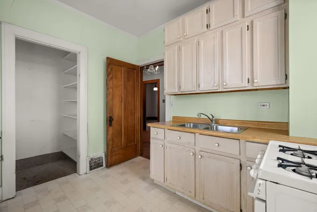 a kitchen with white cabinets