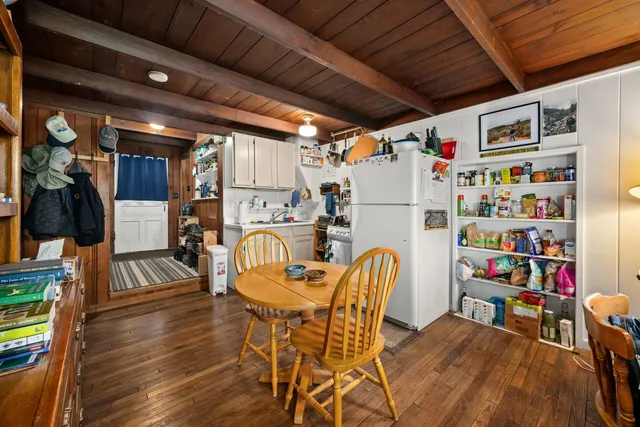 a dining room with furniture and wooden floor