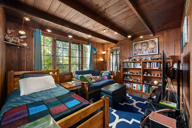 a living room with furniture and a book shelf