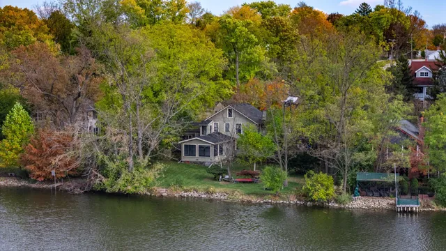 an aerial view of a house with a yard basket ball court and outdoor seating