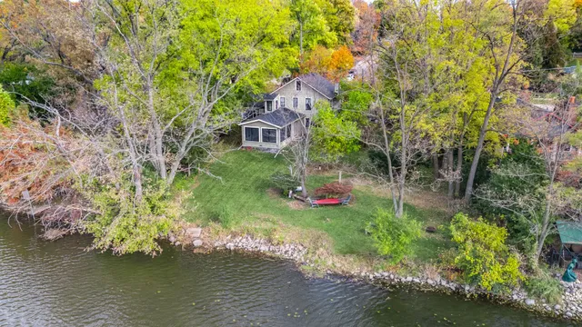 a backyard of a house with lots of green space and lake view