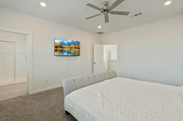a bedroom with a bed and a painting on the wall
