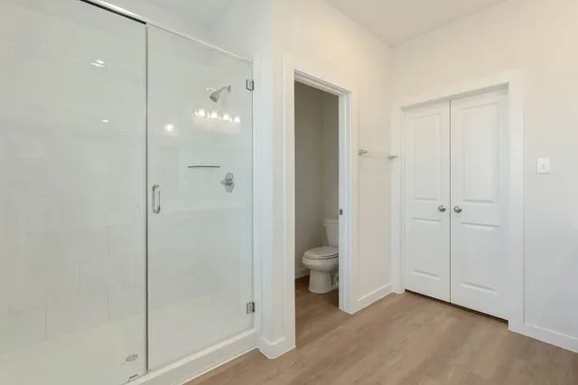 a bathroom that has a glass shower door