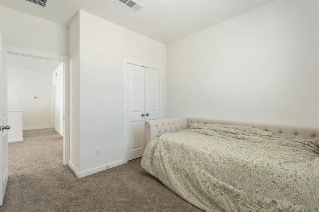 a bedroom with a bed and a mirror