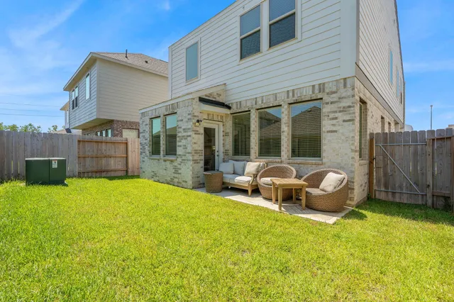 a view of a house with backyard porch and sitting area