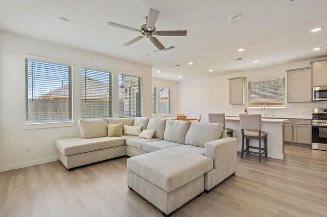 a living room with furniture and a large window