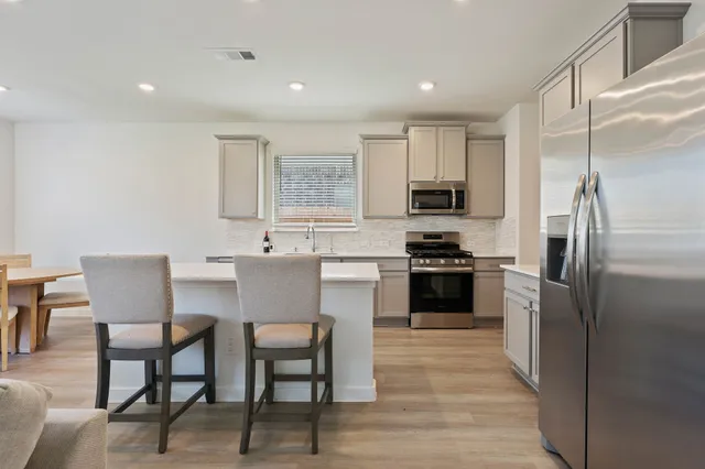 a kitchen with a sink cabinets and stainless steel appliances