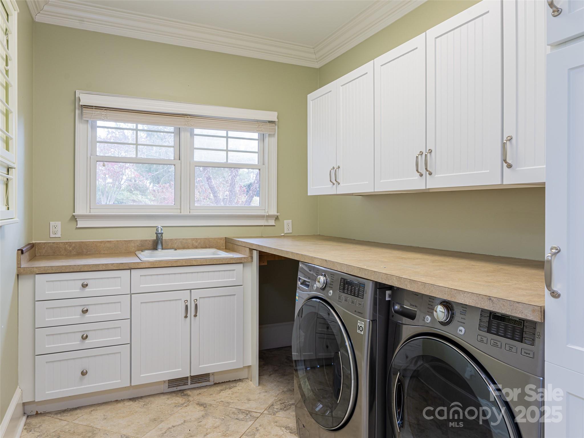 10 Walnut Lane Fletcher, NC 28732 - Photo 22 of 48 a utility room with cabinets washer and dryer