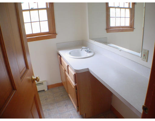 26 Stoneybrook Road Grafton, MA 01536 - Photo 16 of 28 a bathroom with a sink a window and a mirror