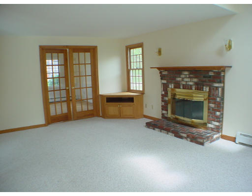 26 Stoneybrook Road Grafton, MA 01536 - Photo 7 of 28 an empty room with windows and fireplace