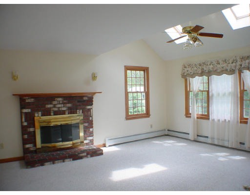 26 Stoneybrook Road Grafton, MA 01536 - Photo 8 of 28 an empty room with fireplace and windows