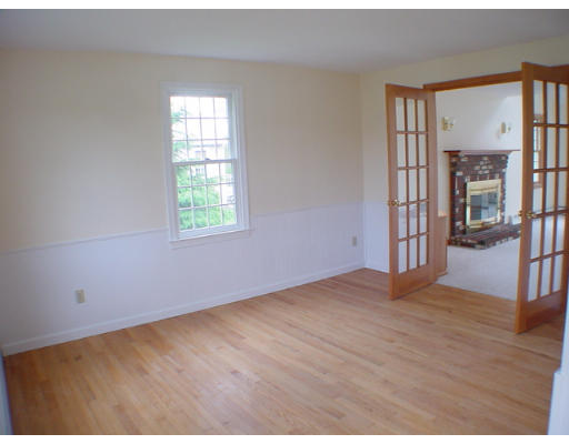 26 Stoneybrook Road Grafton, MA 01536 - Photo 9 of 28 an empty room with wooden floor and a window