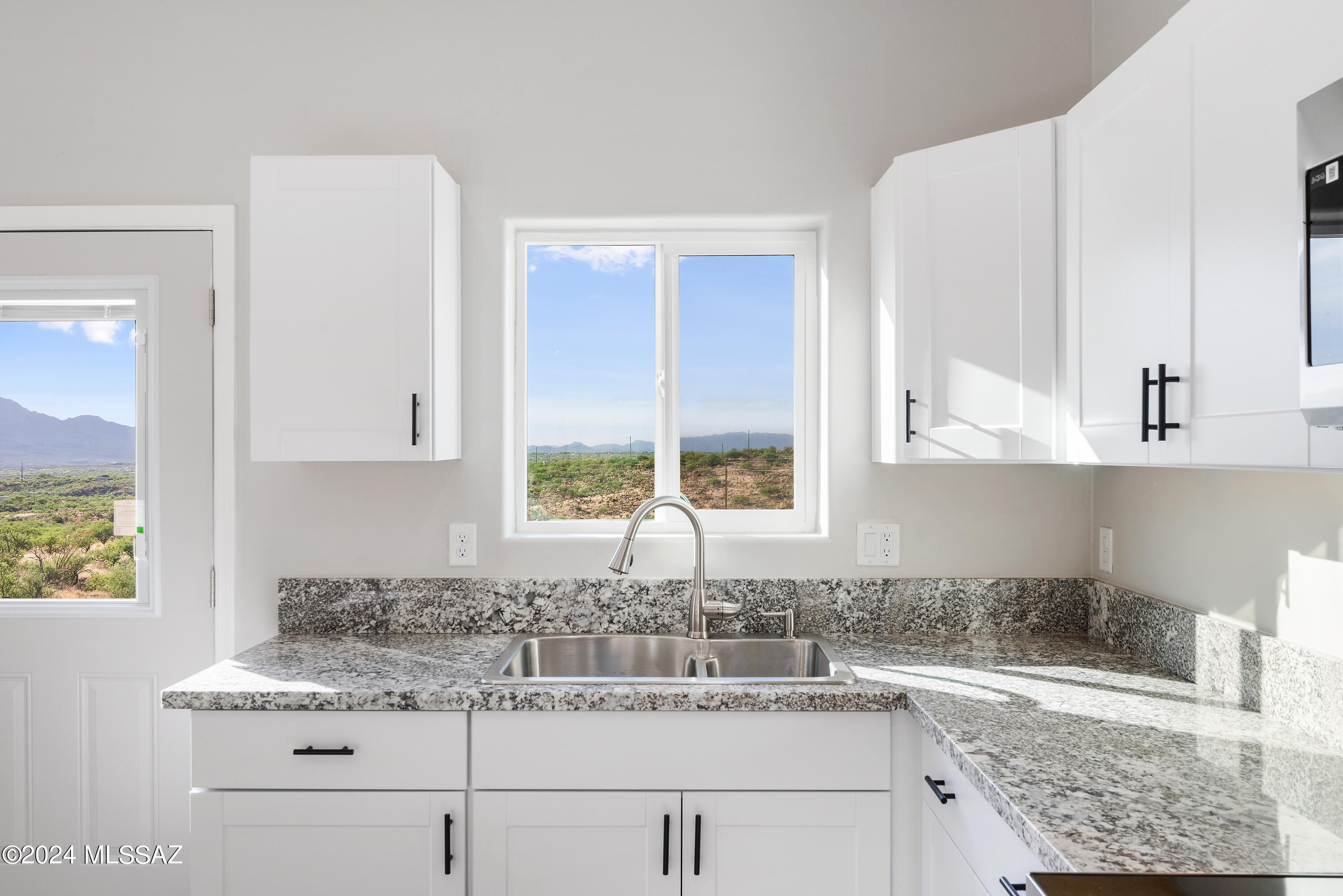 162 Camino Embarcadero Rio Rico, AZ 85648 - Photo 20 of 35 a kitchen with granite countertop a sink and a stove