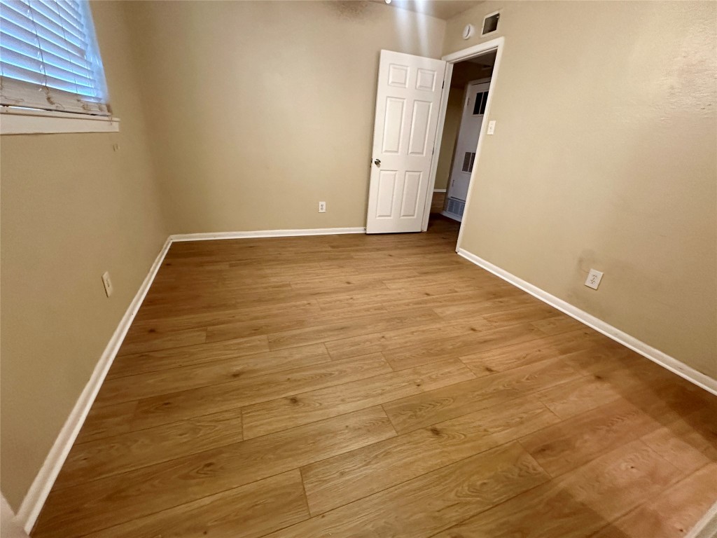 803 West 28th Street, Unit 106 Austin, TX 78705 - Photo 12 of 20 an empty room with wooden floor