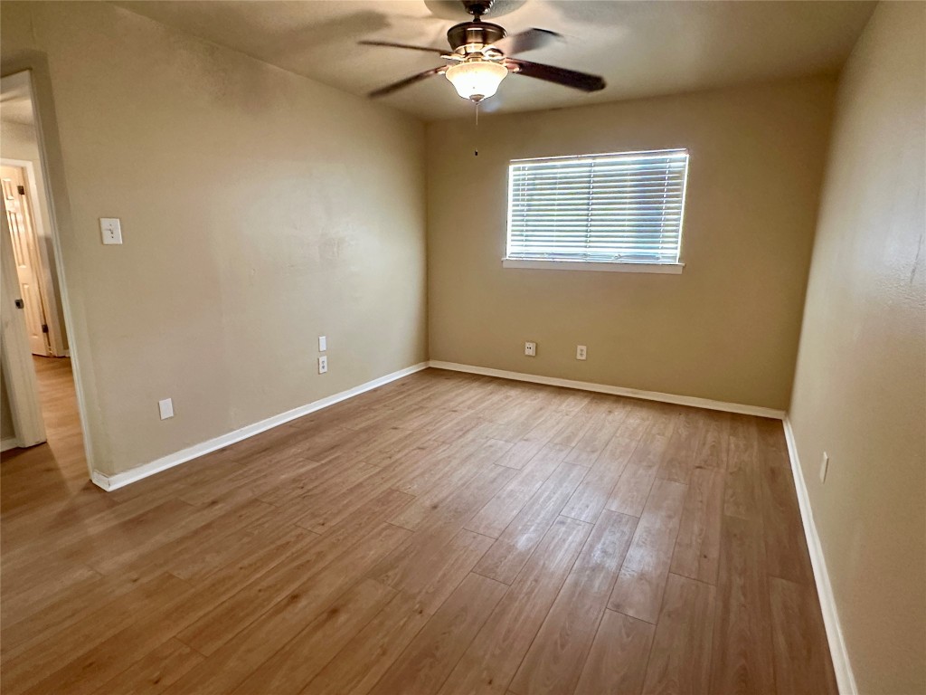 803 West 28th Street, Unit 106 Austin, TX 78705 - Photo 6 of 20 a view of an empty room with wooden floor and a window