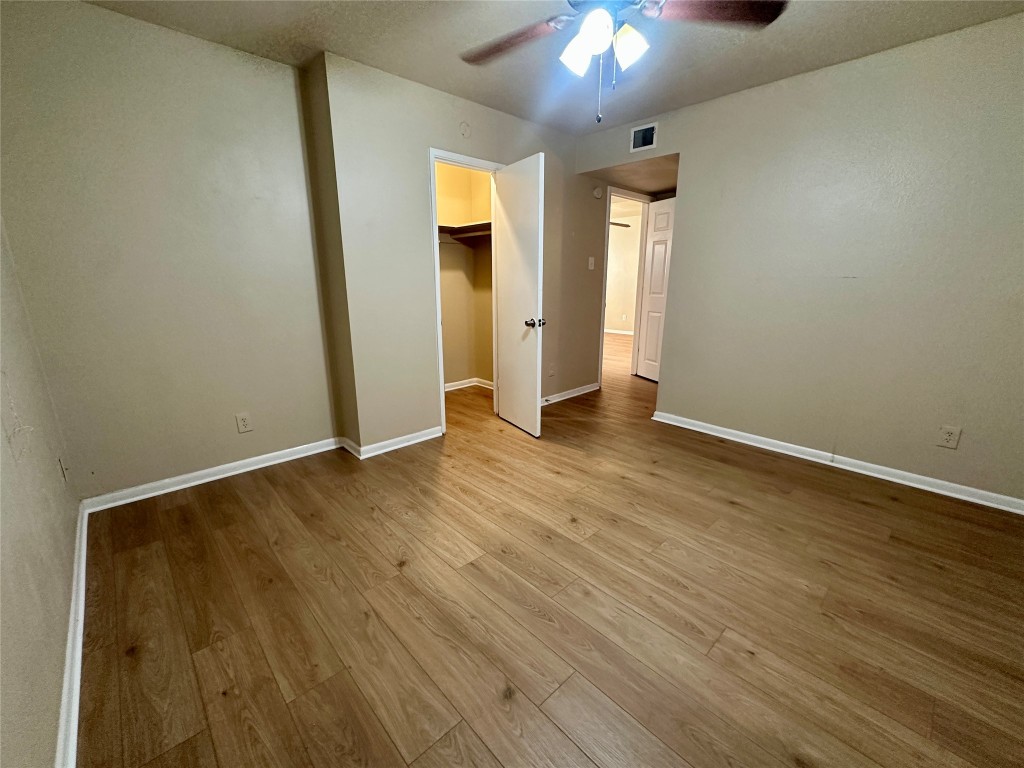 803 West 28th Street, Unit 106 Austin, TX 78705 - Photo 8 of 20 an empty room with wooden floor and windows