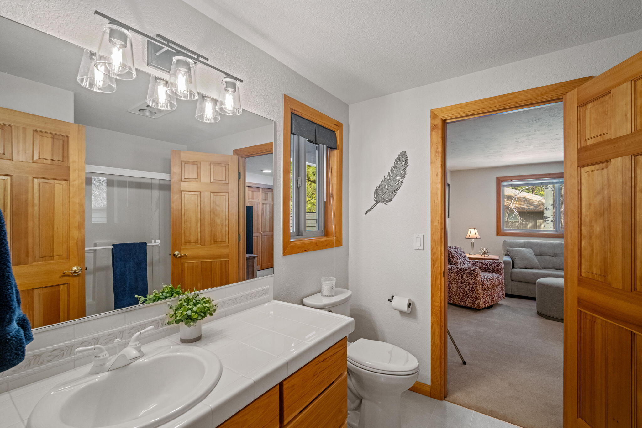 17948 Shadow Lane, Unit 7 Sunriver, OR 97707 - Photo 56 of 92 a bathroom with a granite countertop sink a toilet and a mirror