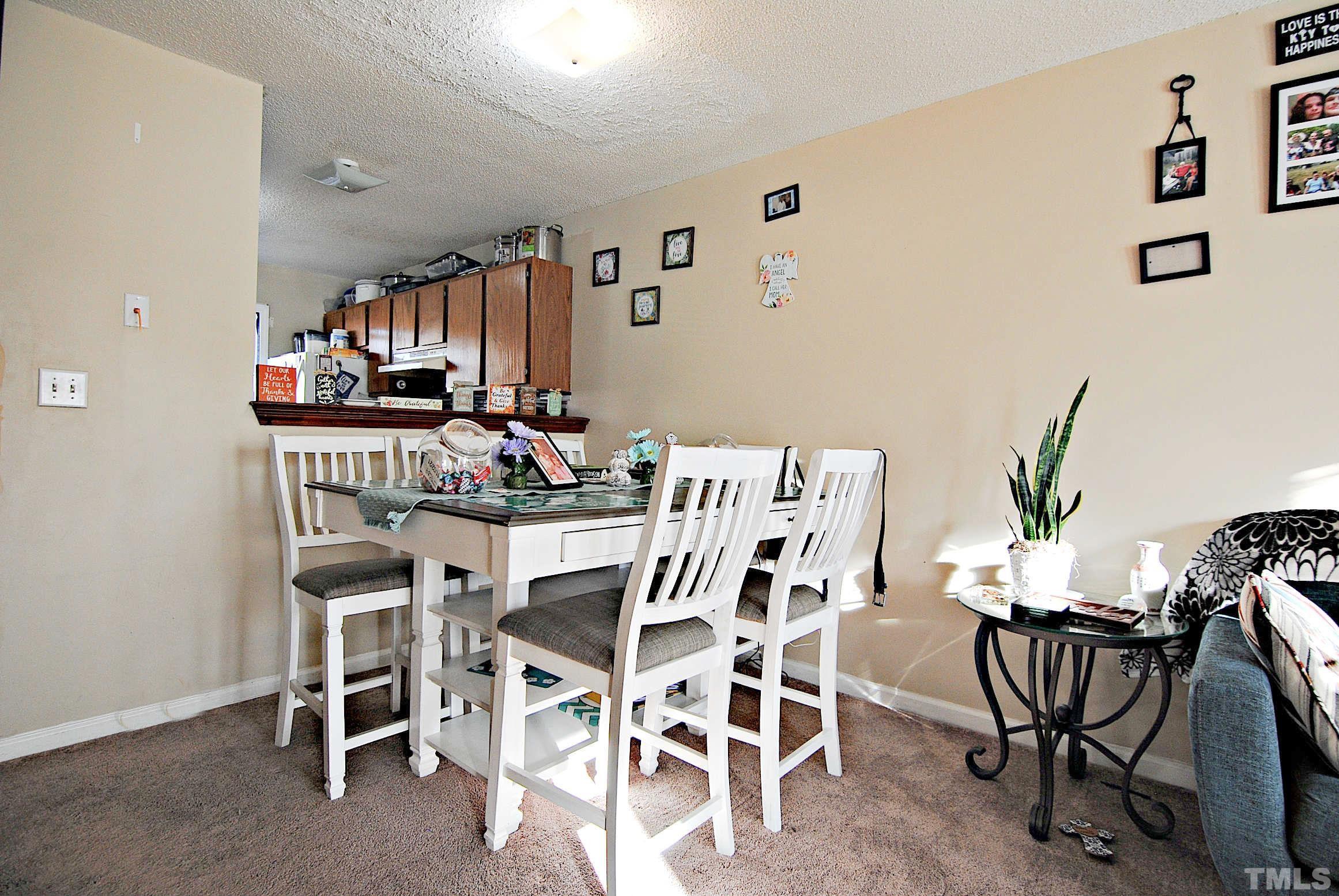 8263 Merriweather Circle Raleigh, NC 27616 - Photo 5 of 10 a view of a dining room with furniture and a potted plant