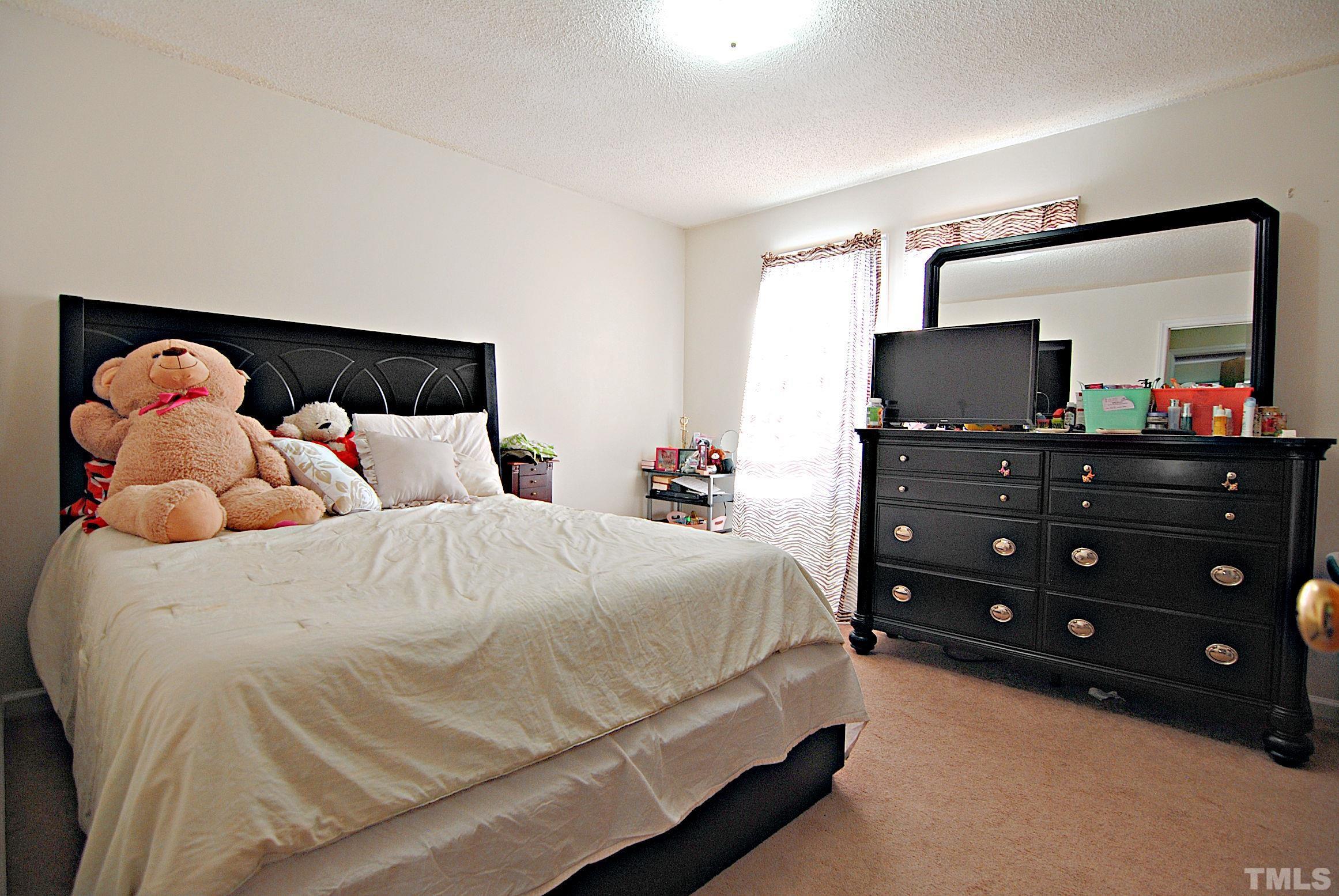 8263 Merriweather Circle Raleigh, NC 27616 - Photo 7 of 10 a bedroom with a bed and a television