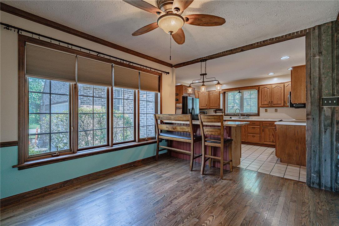 652 Old State Road Oley, PA 19547 - Photo 12 of 54 Rich hardwood flooring leads to a functional kitchen with warm wood cabinetry.
