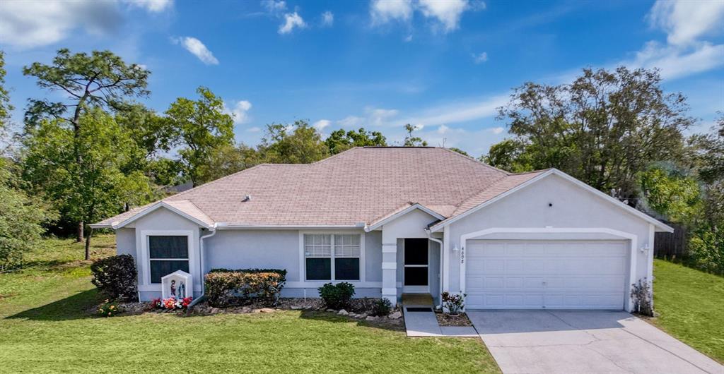 4608 Elwood Road Spring Hill, FL 34609 - Photo 1 of 1 a view of a house with backyard sitting area and garden