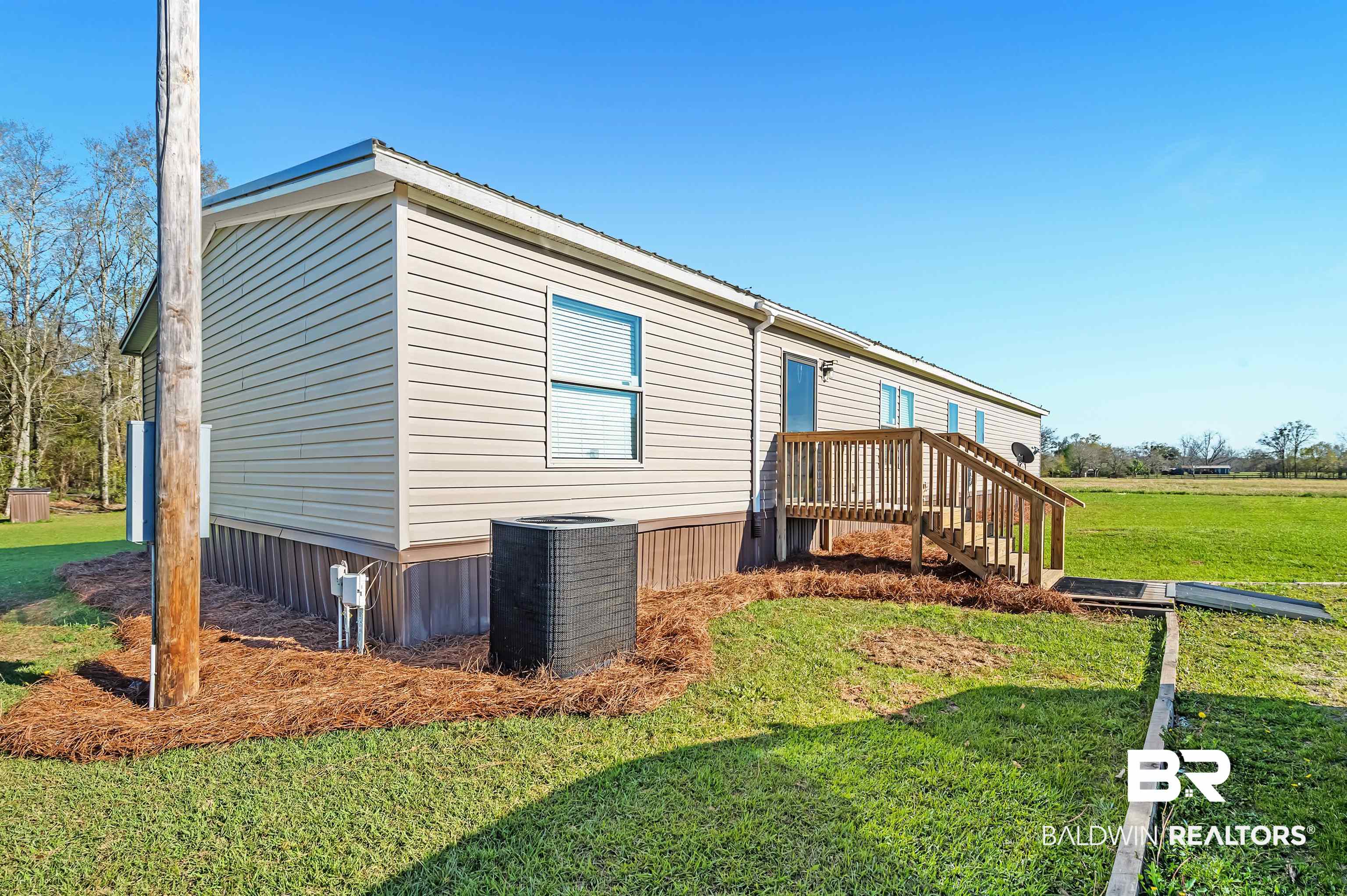 23233 Forland Road Silverhill, AL 36576 - Photo 7 of 33 View of side of property with central air condition unit and a yard