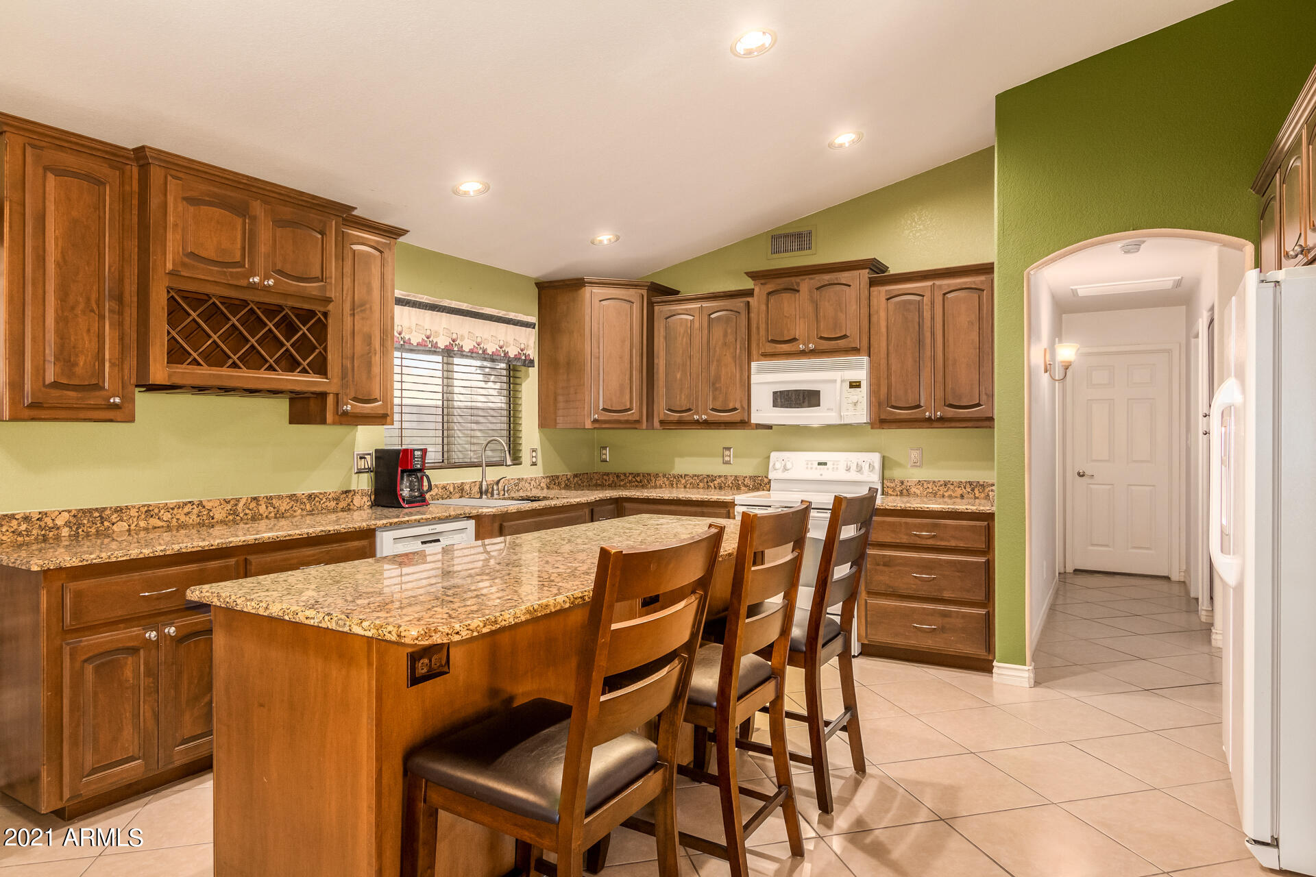 253 East Nunneley Road Gilbert, AZ 85296 - Photo 9 of 25 a kitchen with kitchen island granite countertop a sink and counter space