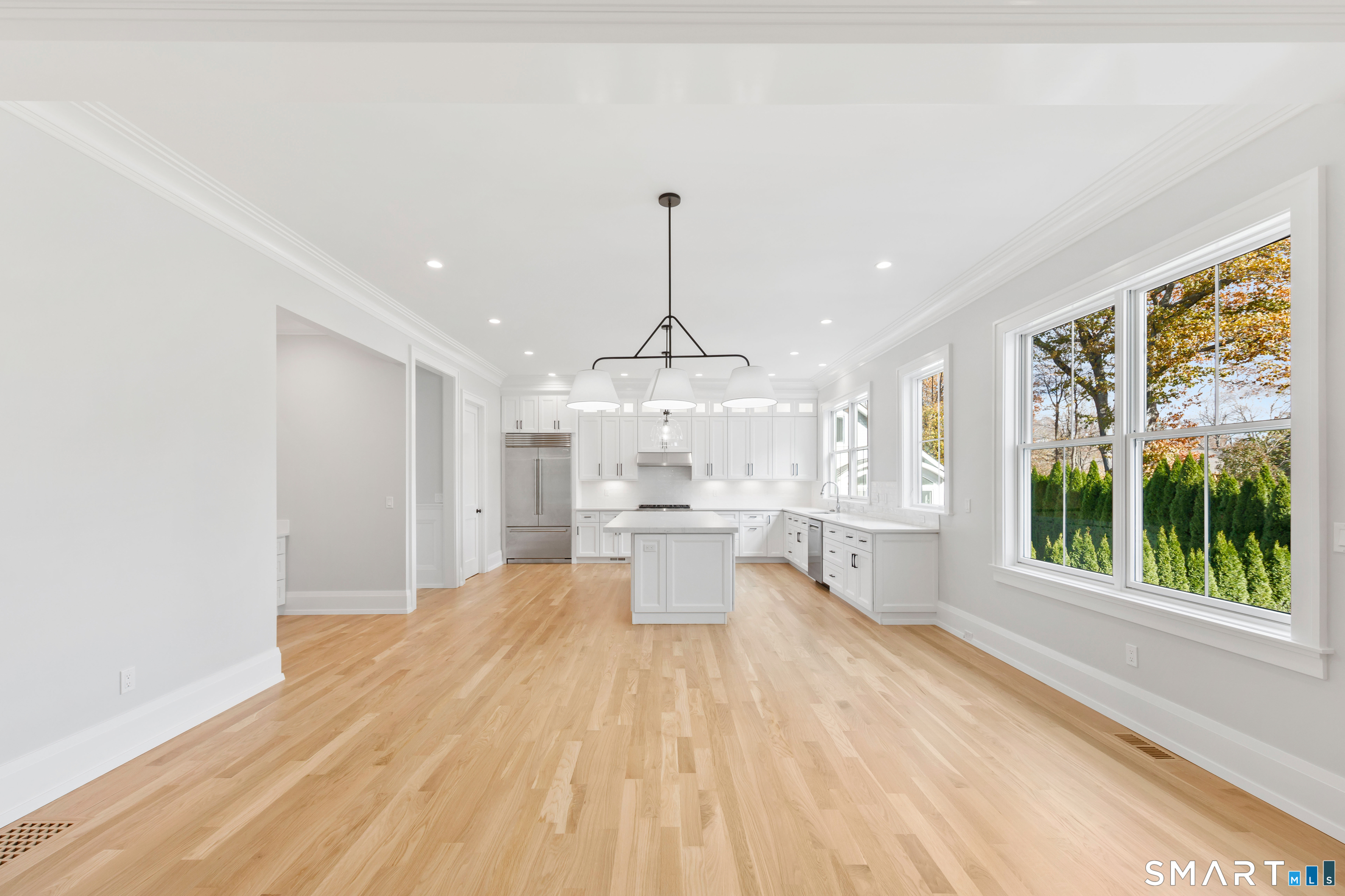 119 Harrison Avenue New Canaan, CT 06840 - Photo 11 of 40 a large room with chandelier fan and windows