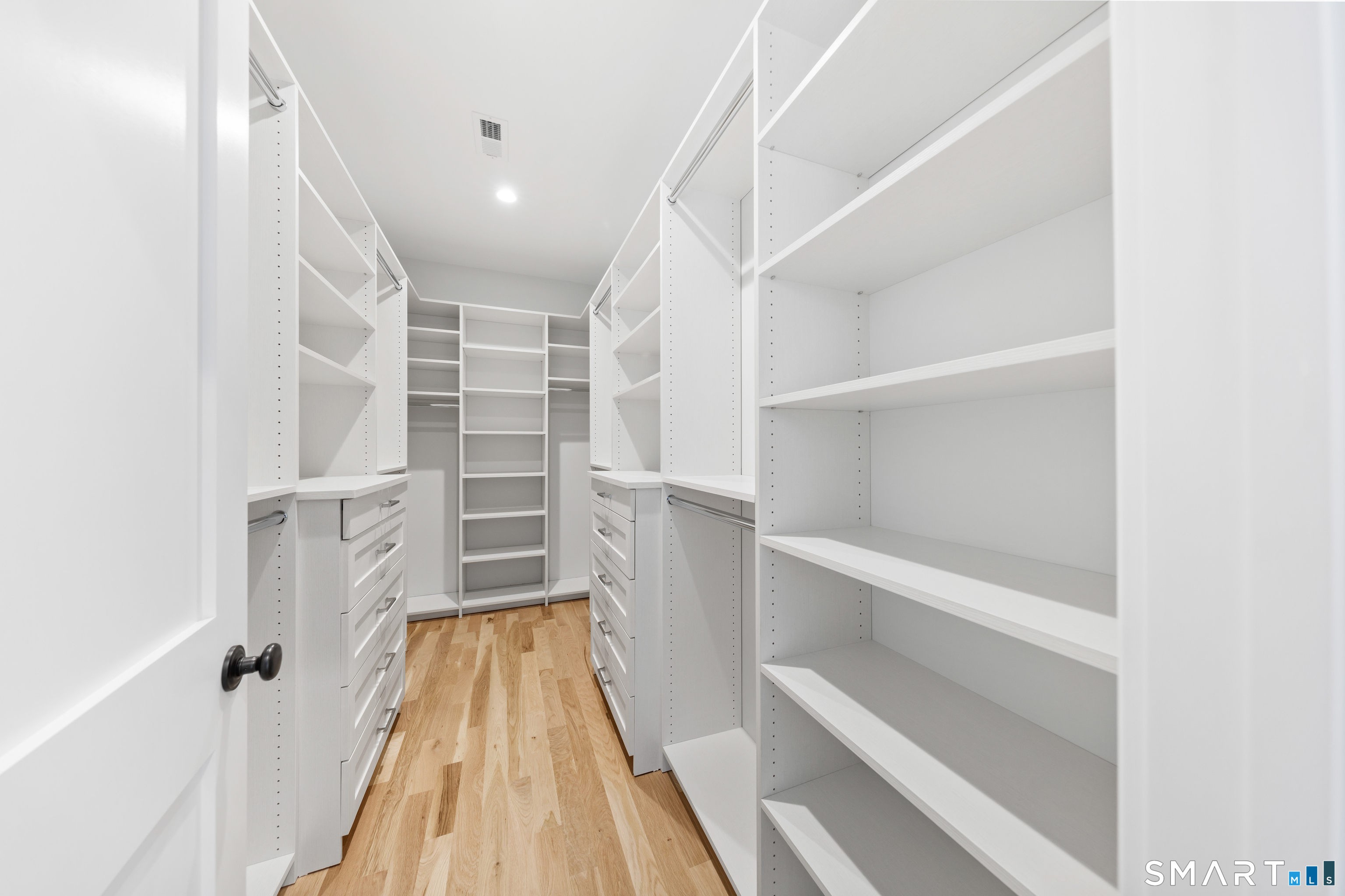 119 Harrison Avenue New Canaan, CT 06840 - Photo 27 of 40 a view of walk in closet with empty racks