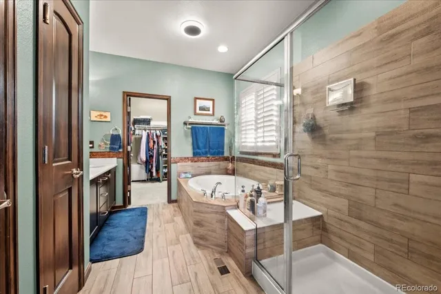 a view of walk in closet with clothes