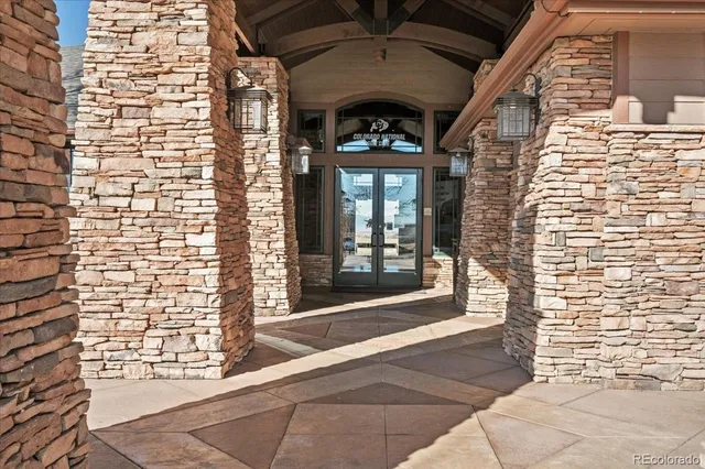 a view of swimming pool with outdoor seating and trees in the background