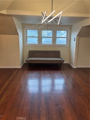 a room with wooden floors and a window