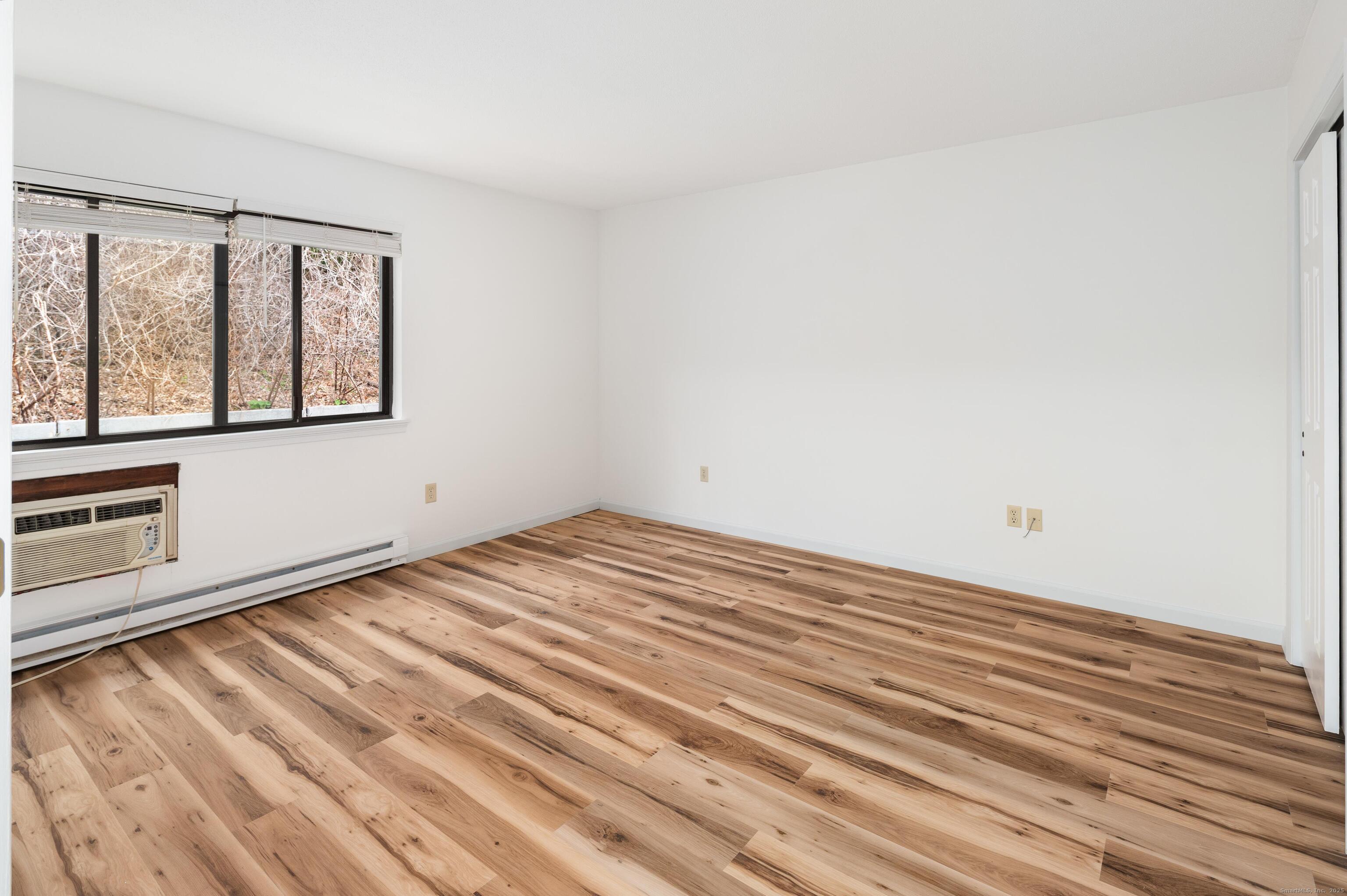 8 Driftway Road, Unit C1 Danbury, CT 06811 - Photo 14 of 23 a view of empty room with wooden floor and fan