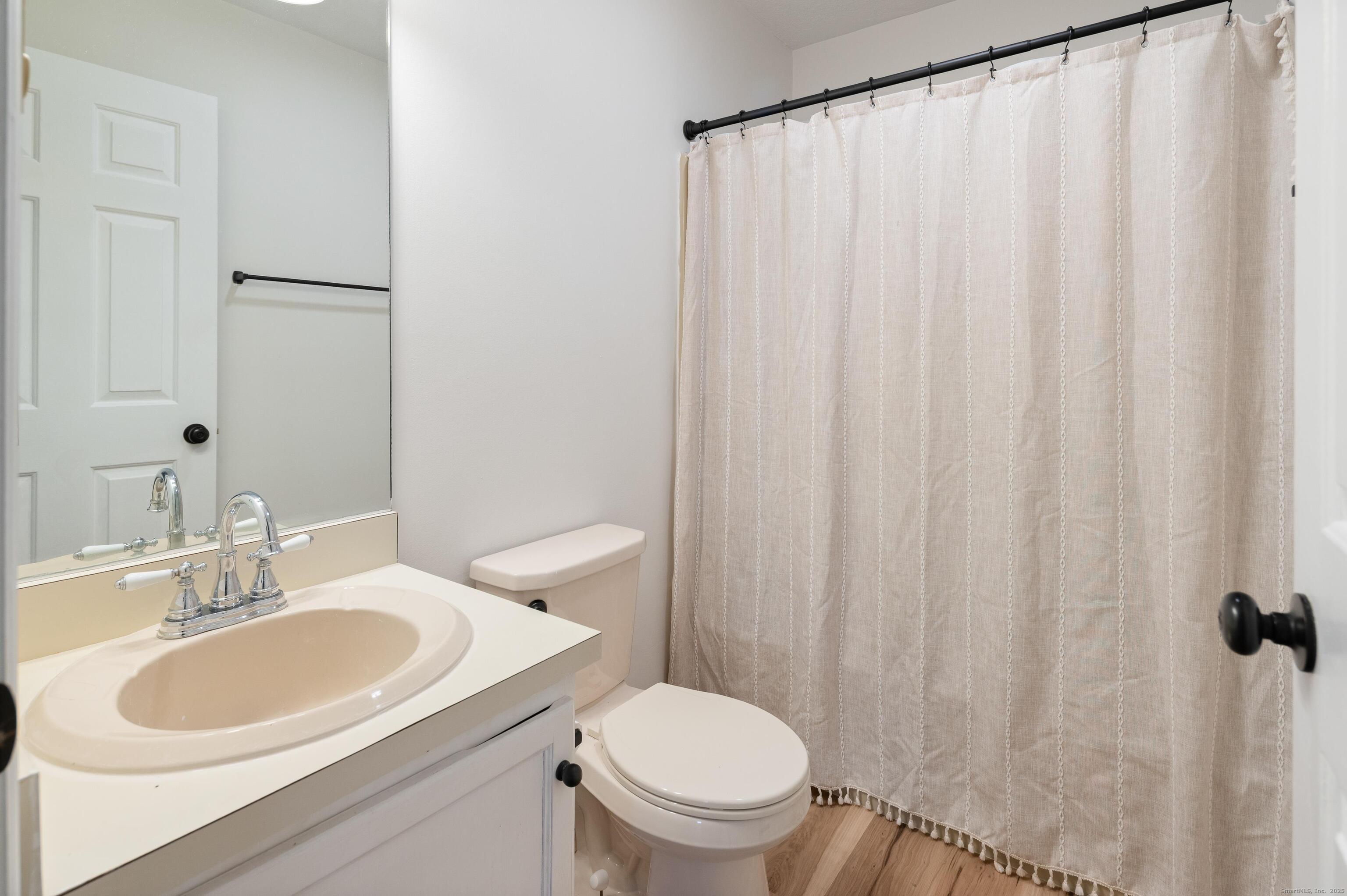 8 Driftway Road, Unit C1 Danbury, CT 06811 - Photo 15 of 23 a bathroom with a sink a toilet and a mirror