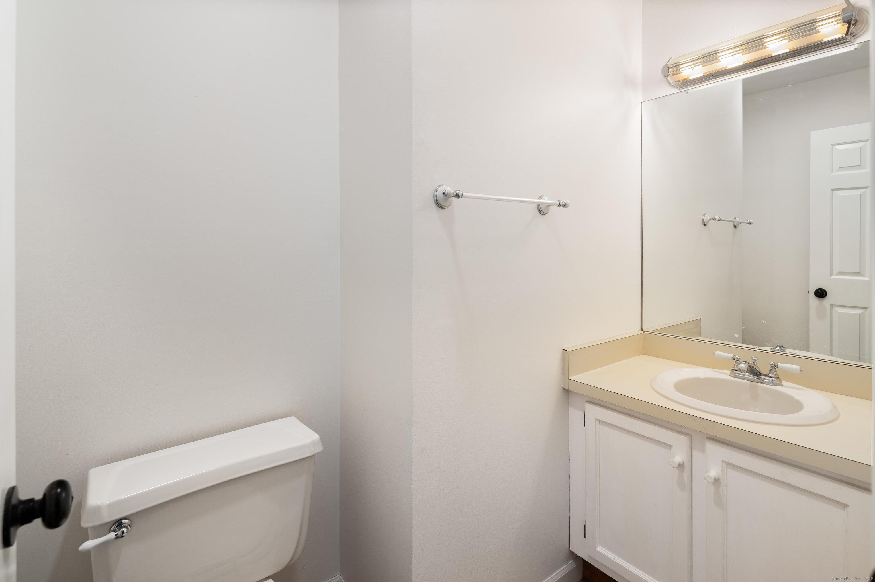 8 Driftway Road, Unit C1 Danbury, CT 06811 - Photo 16 of 23 a bathroom with a sink a toilet and a mirror